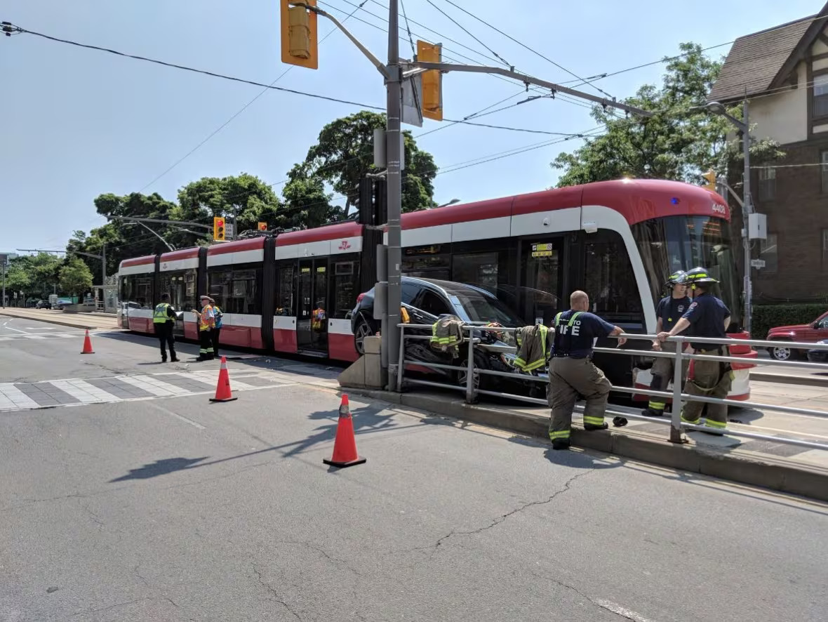 Car Wedged Against Streetcar